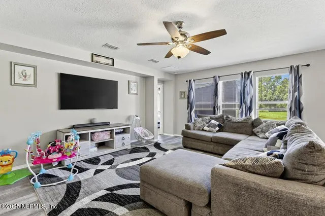 a living room with furniture and a flat screen tv