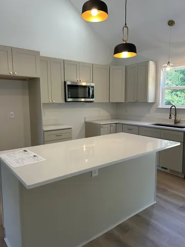 a kitchen with a sink a counter and chairs