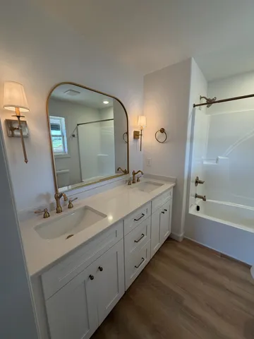 a spacious bathroom with a double vanity sink and a mirror