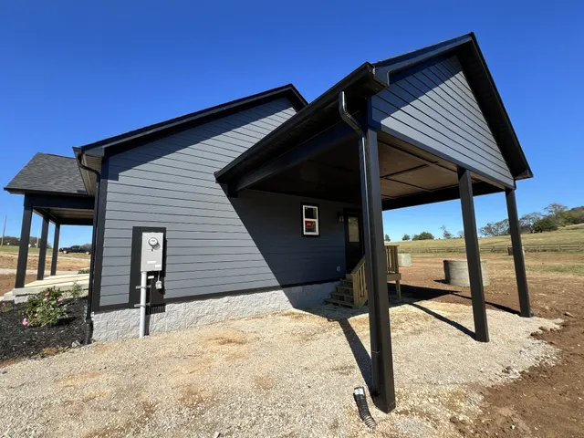 a backyard of a house with table and chairs