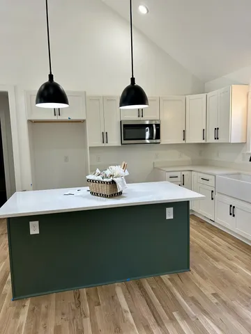 a kitchen with stainless steel appliances granite countertop a sink a stove and a refrigerator