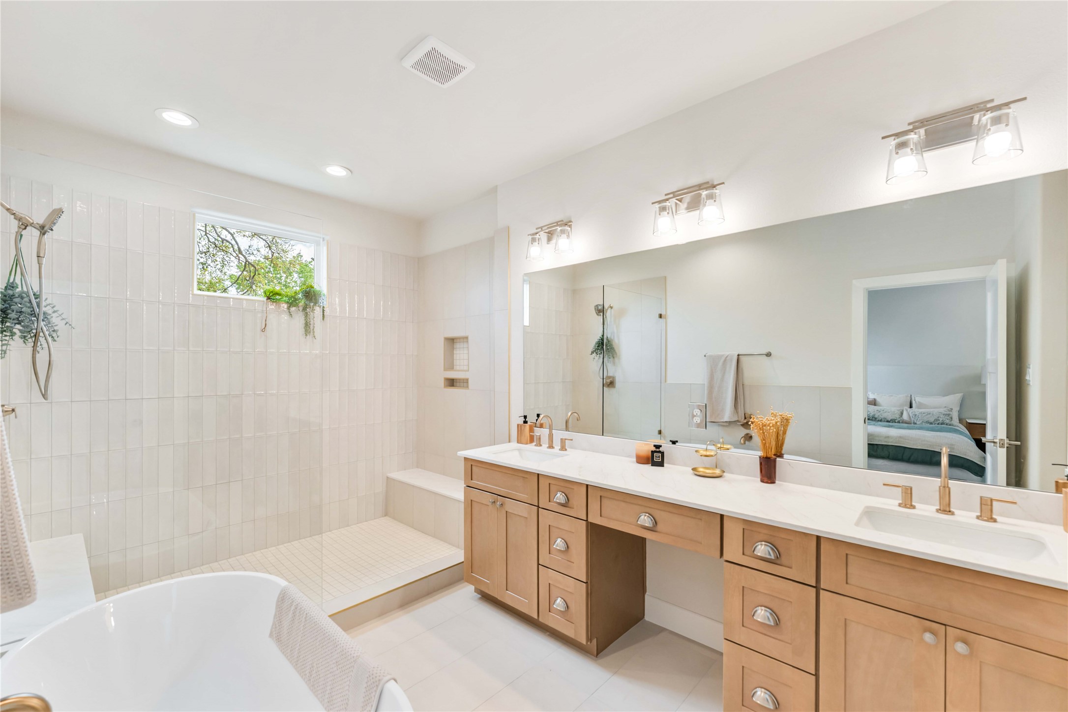 11108 Bauman Road Houston, TX 77076 - Photo 14 of 25 a bathroom with a double vanity sink mirror and bathtub
