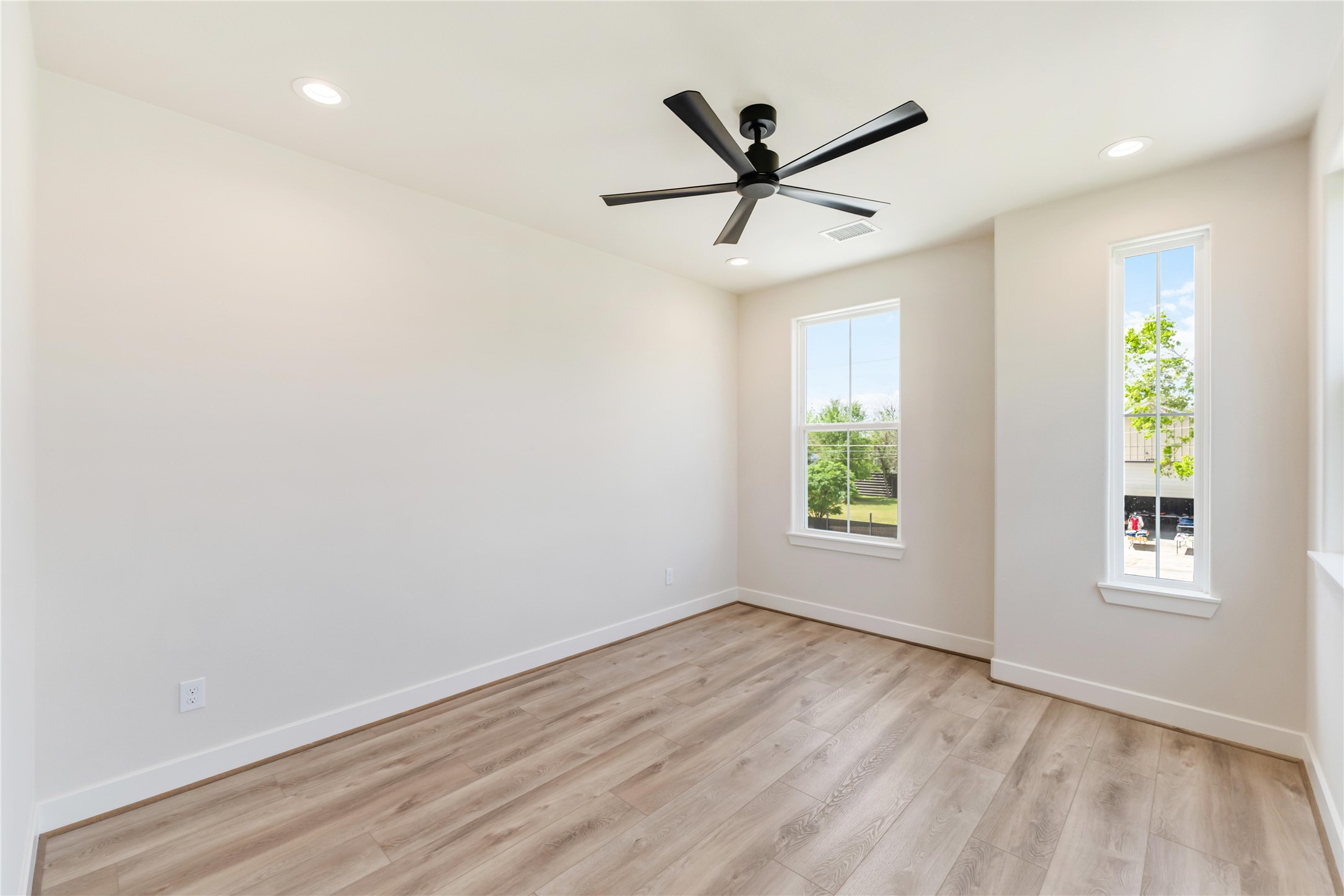 11108 Bauman Road Houston, TX 77076 - Photo 17 of 25 a view of a big room with wooden floor closet and windows