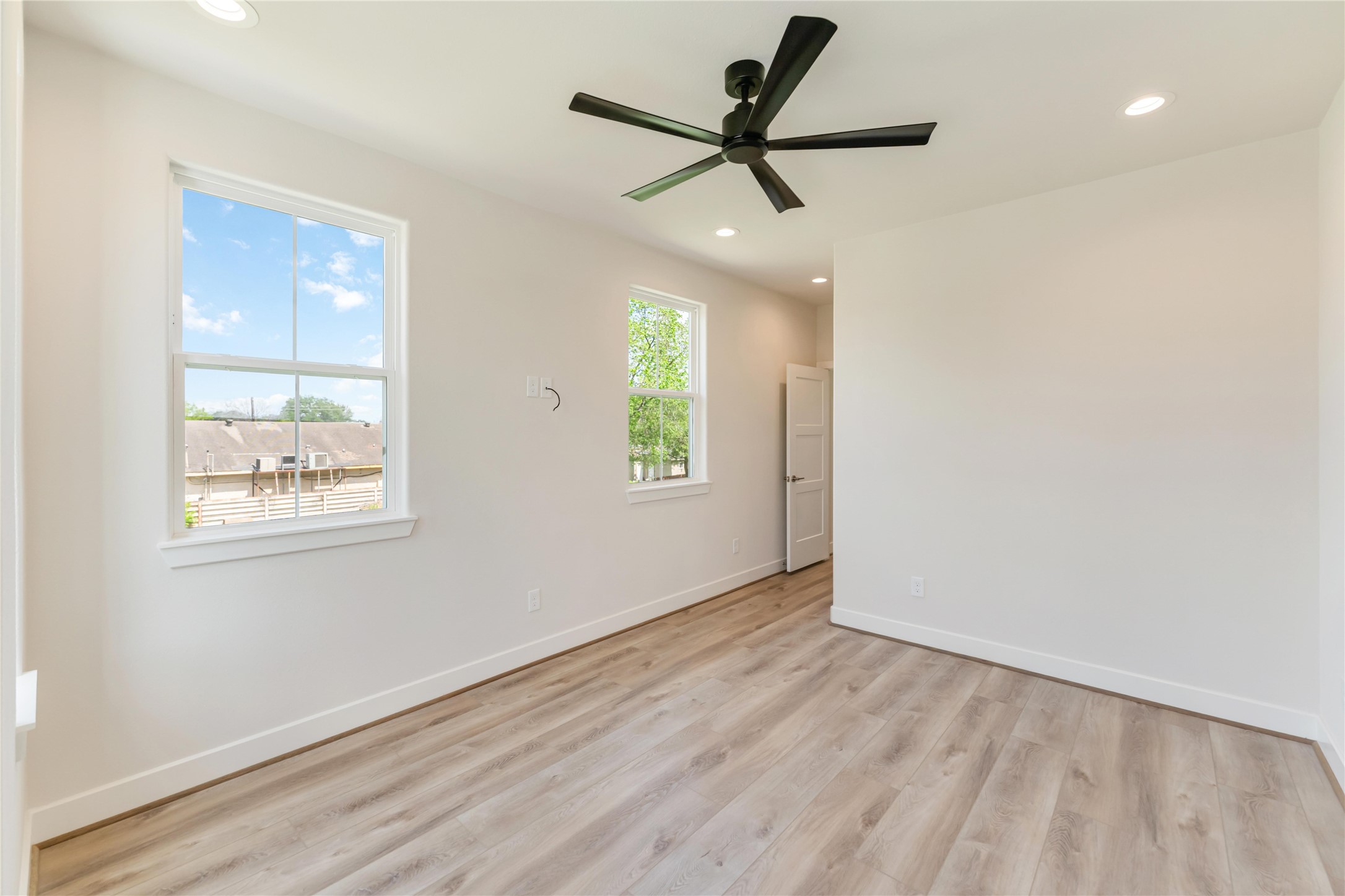 11108 Bauman Road Houston, TX 77076 - Photo 18 of 25 a view of a big room with wooden floor and windows
