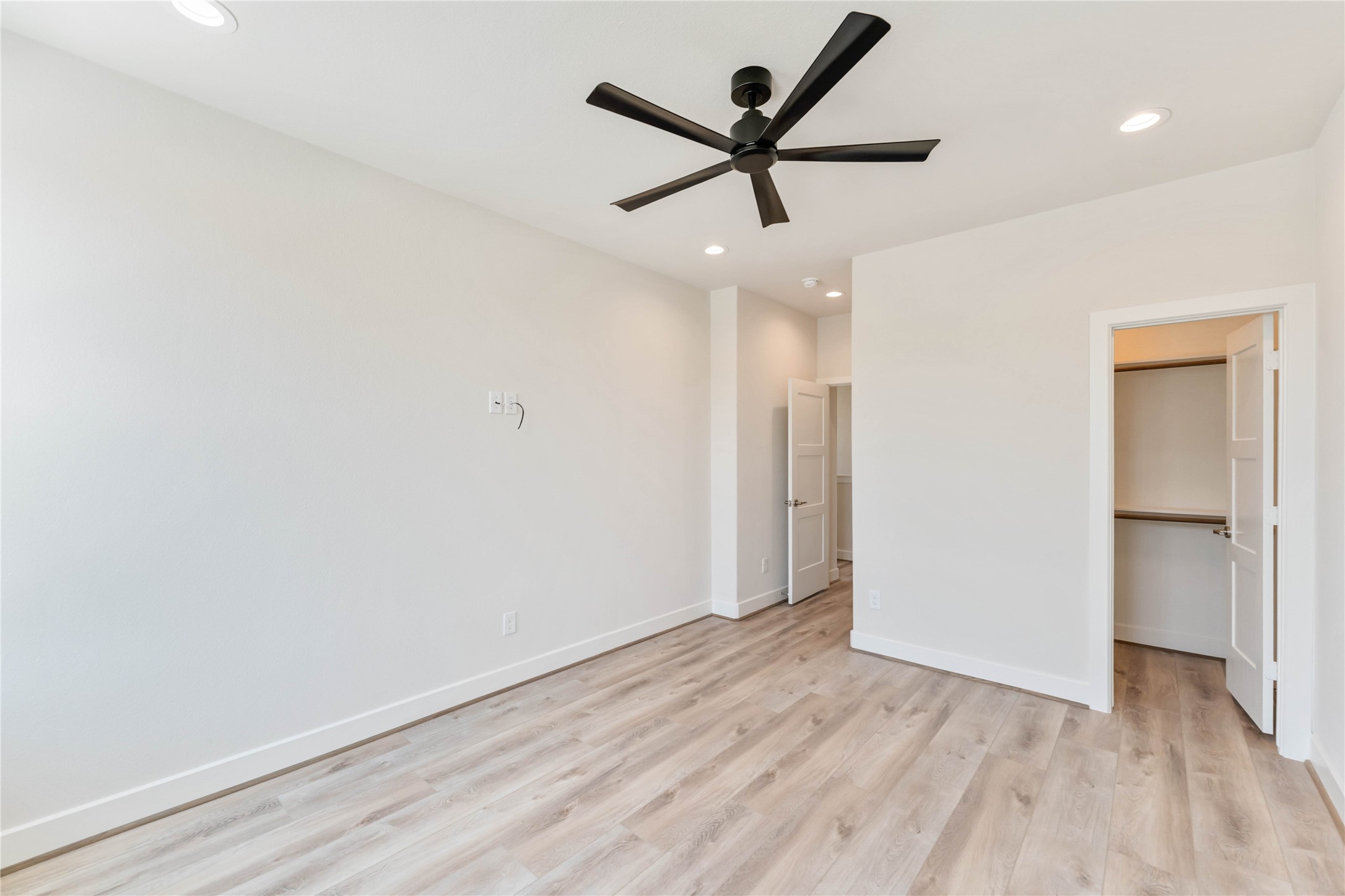11108 Bauman Road Houston, TX 77076 - Photo 20 of 25 an empty room with wooden floor and ceiling fan