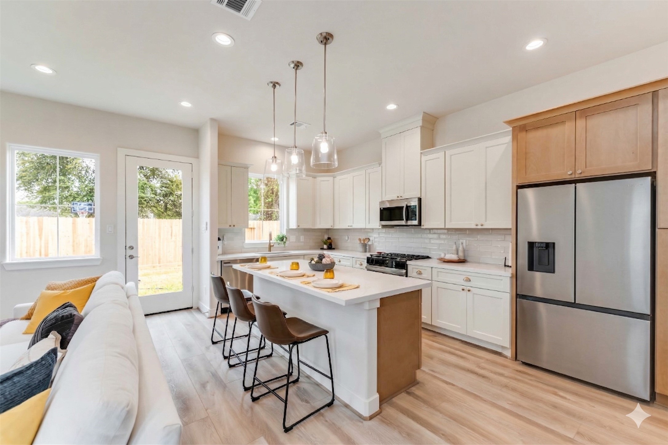11108 Bauman Road Houston, TX 77076 - Photo 4 of 25 a kitchen with a refrigerator a stove a sink dishwasher with a dining table and chairs