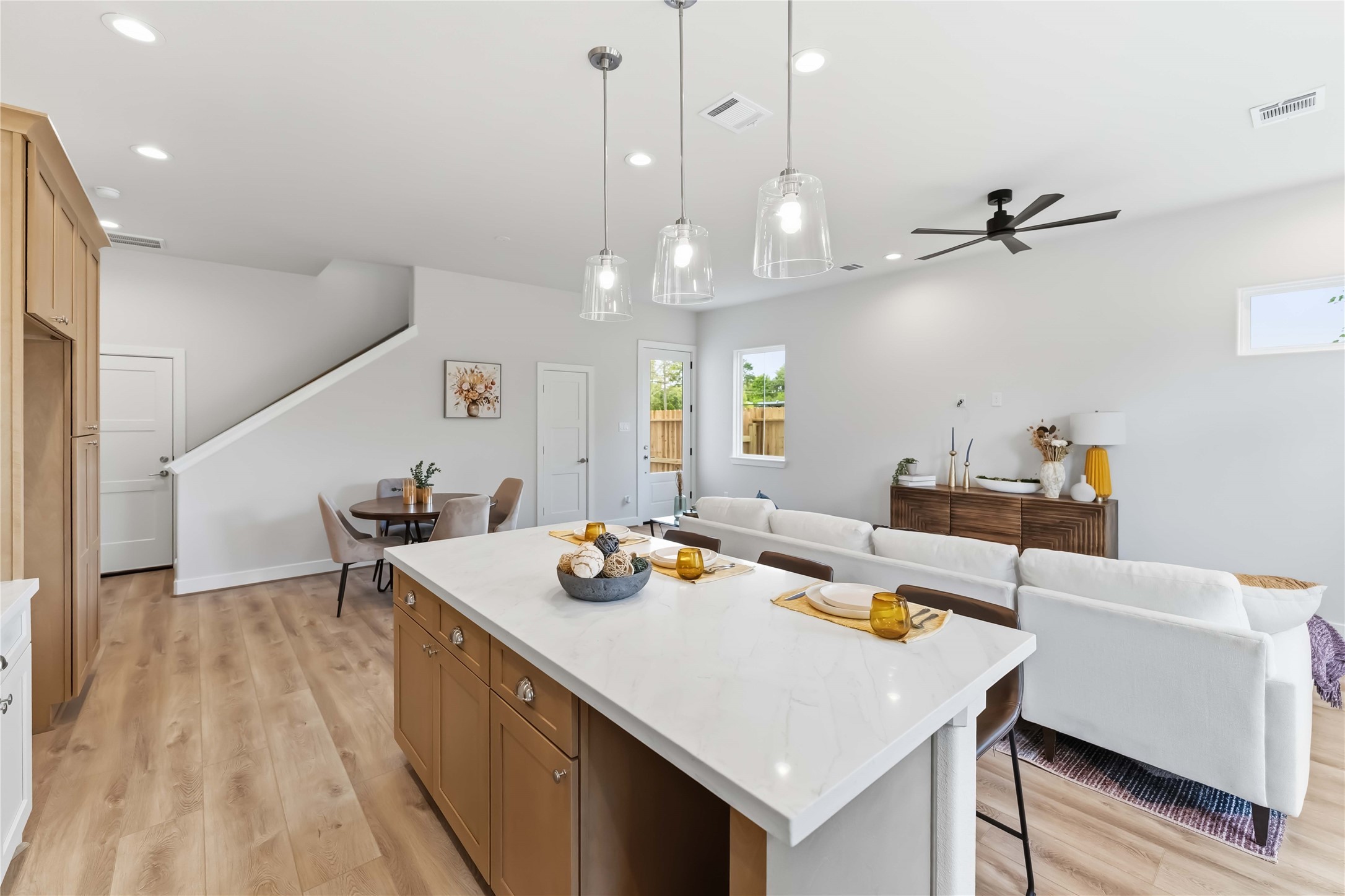 11108 Bauman Road Houston, TX 77076 - Photo 8 of 25 a kitchen with a table chairs and a chandelier