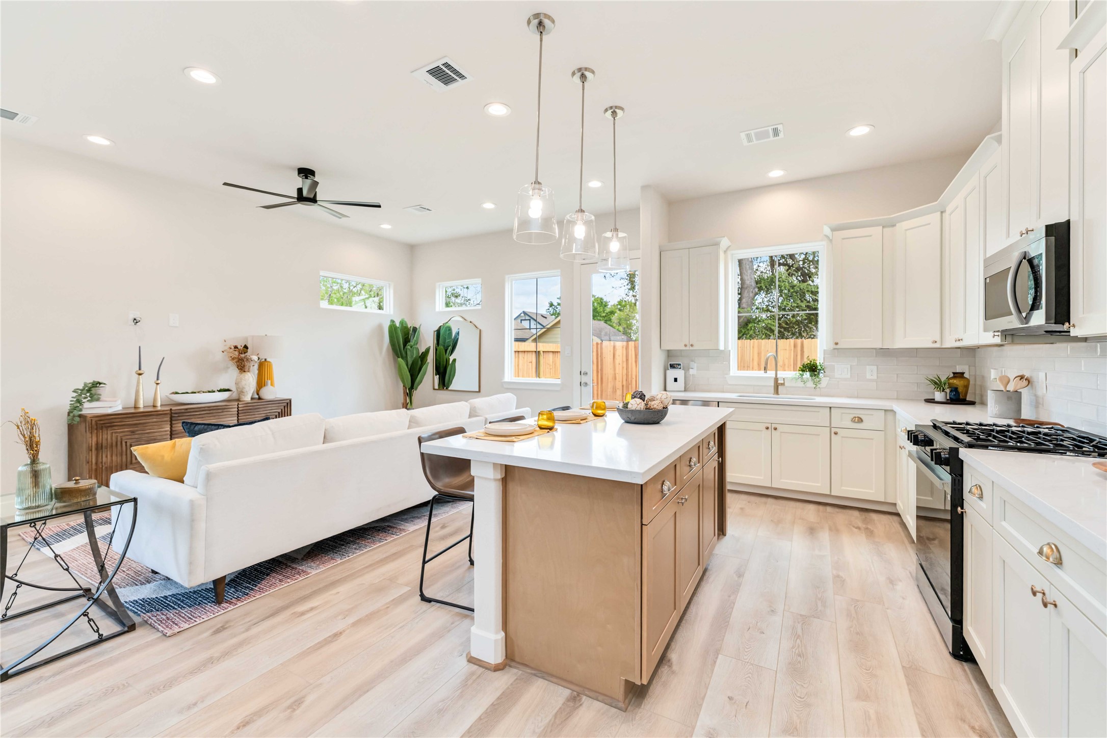 11108 Bauman Road Houston, TX 77076 - Photo 10 of 25 a kitchen with counter top space a sink appliances and cabinets