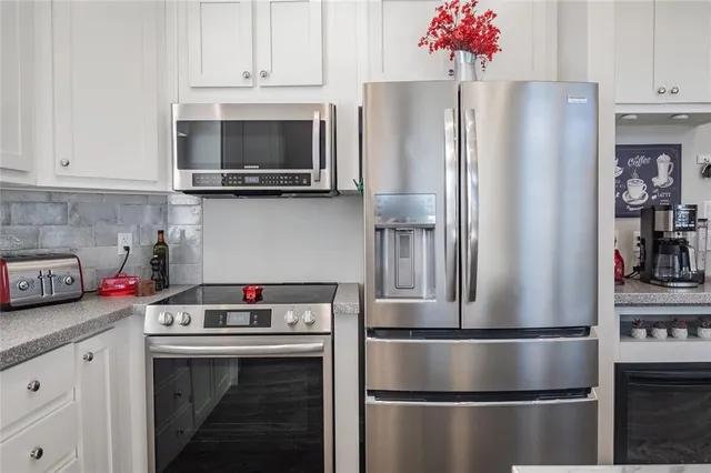a kitchen with stainless steel appliances a refrigerator and a stove