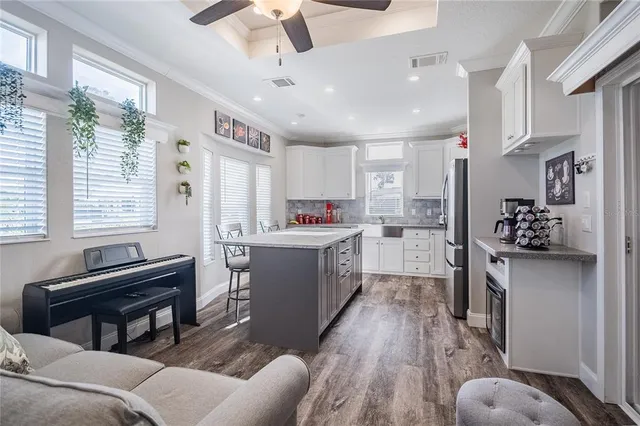 a kitchen with stainless steel appliances kitchen island granite countertop a refrigerator and a stove top oven