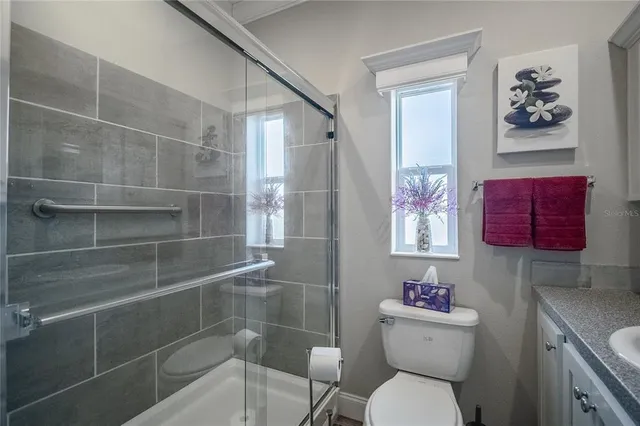 a bathroom with a toilet and a shower