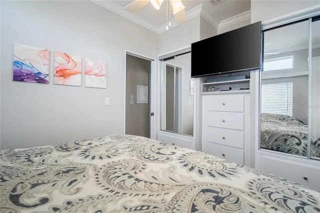 a bedroom with a bed and a flat screen tv
