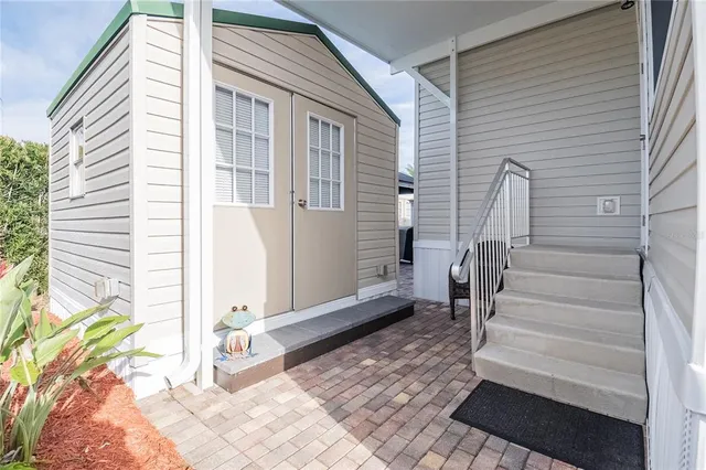 a view of wooden door with a bench