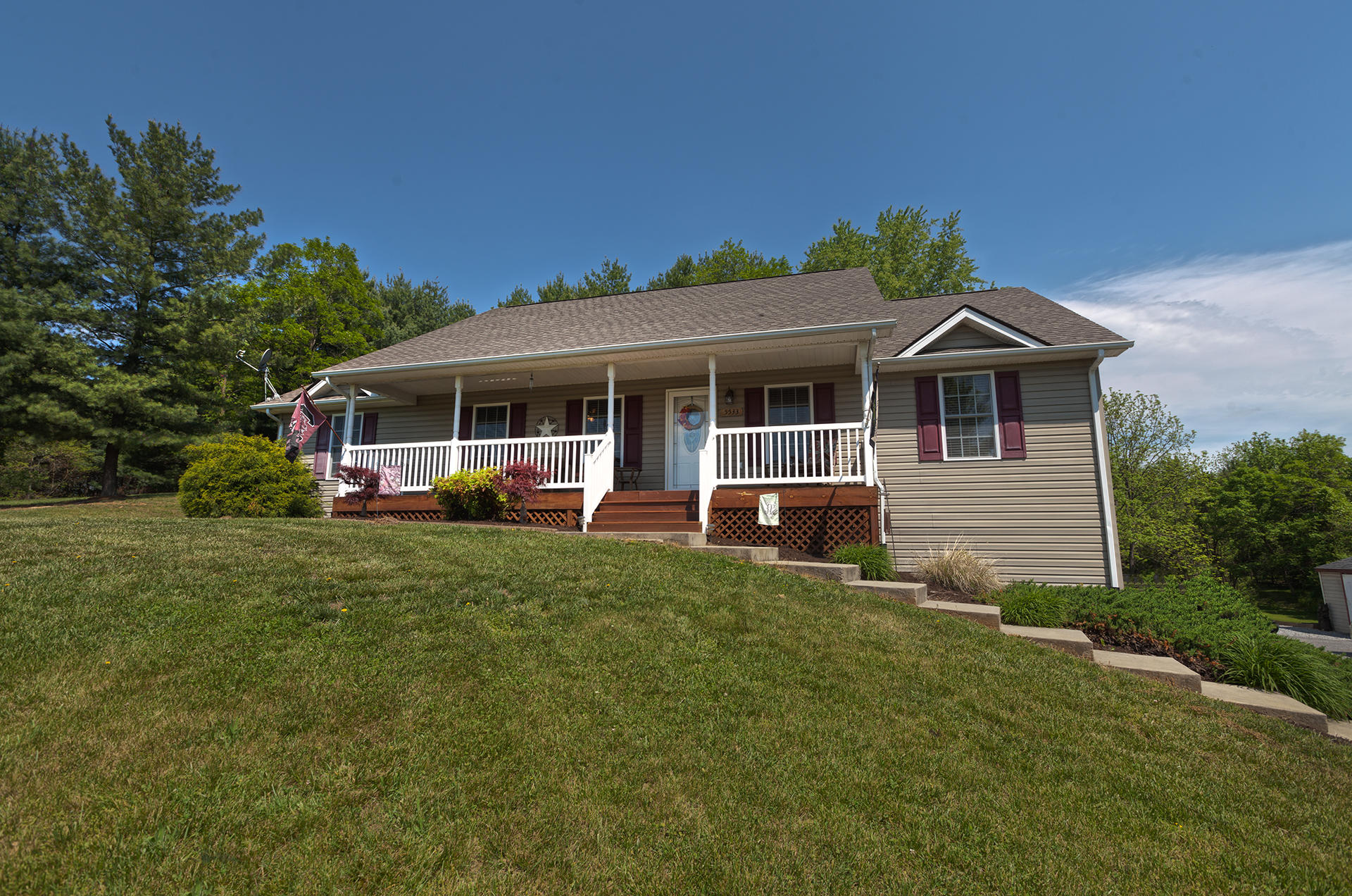 a front view of a house with a garden