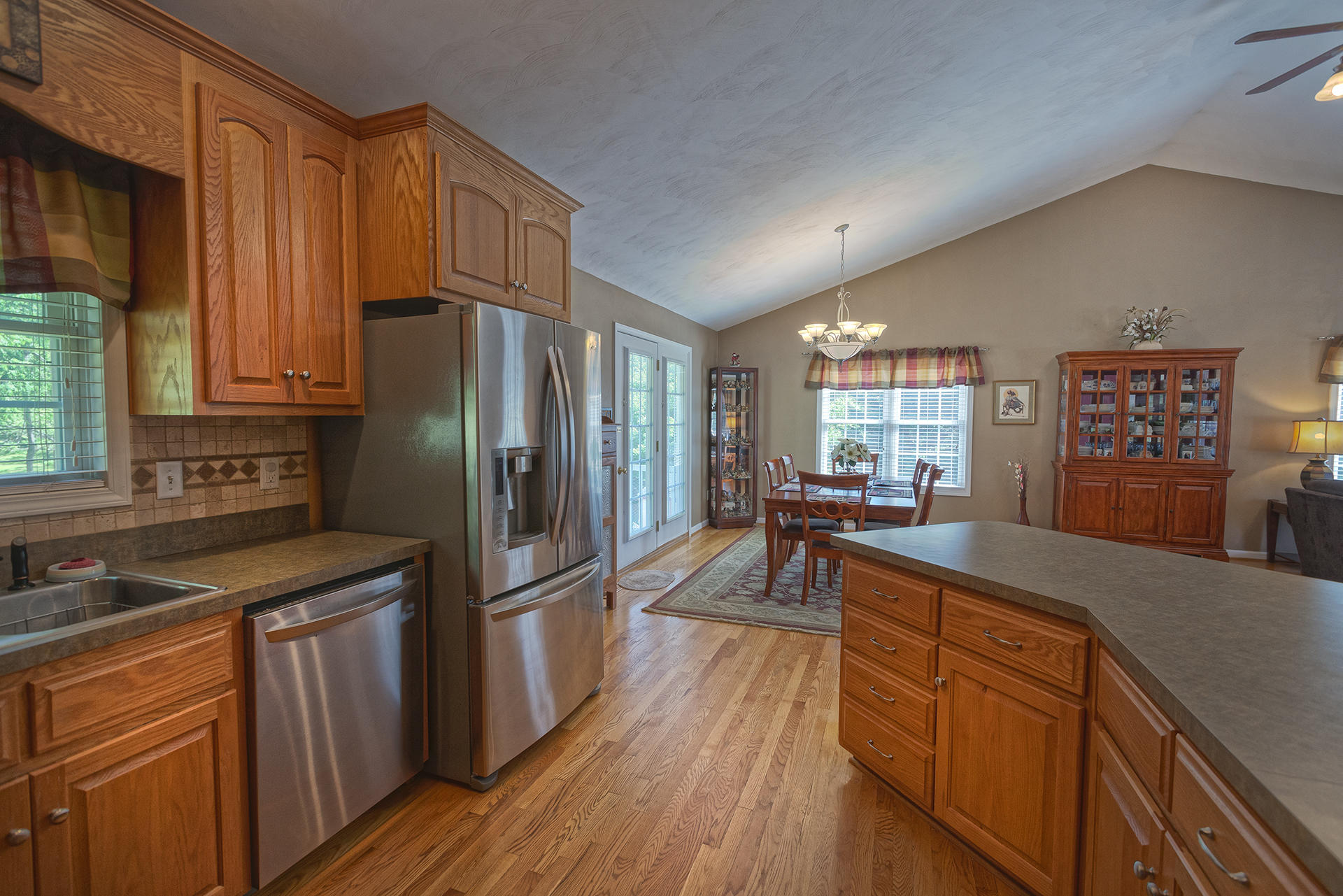 5533 Roanoke Road Troutville, VA 24175 - Photo 14 of 45 a kitchen with stainless steel appliances granite countertop a refrigerator a sink dishwasher a stove and white countertops with wooden floor
