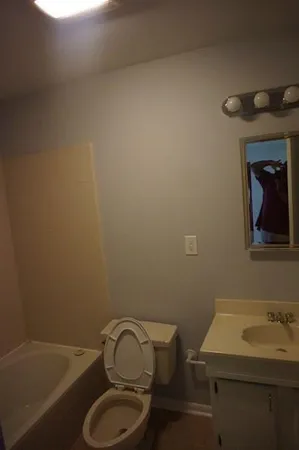 a bathroom with a toilet a sink and bathtub