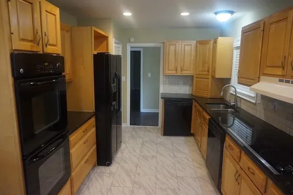 a kitchen with a refrigerator and a stove