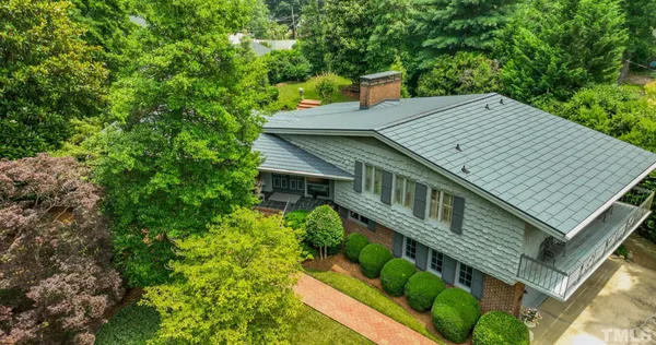 a view of a house with roof deck front of house