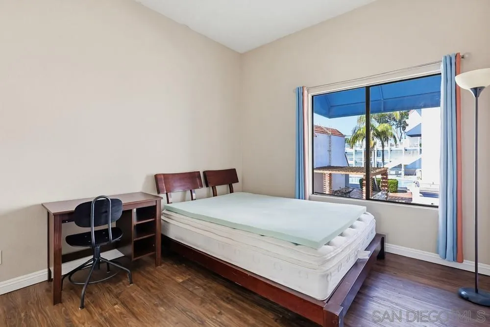 8324 Regents Road, Unit 2E San Diego, CA 92122 - Photo 24 of 31 a bed sitting in a bedroom next to a window