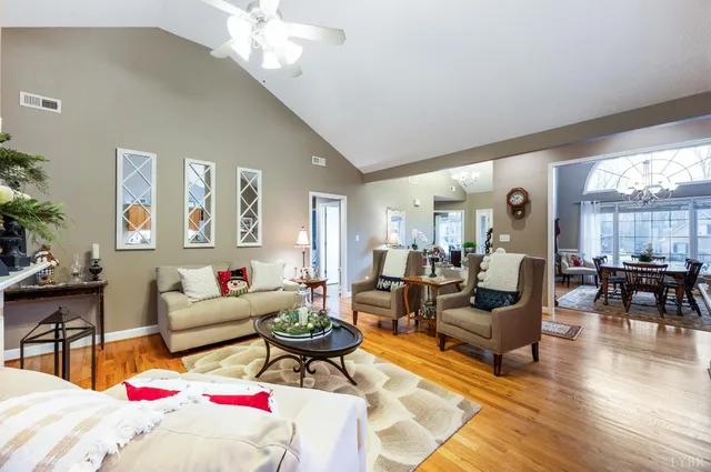 a living room with furniture chandelier and a chandelier