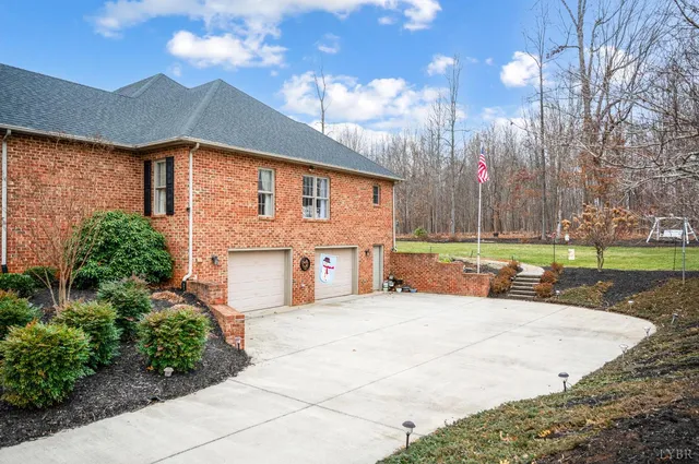 a view of a town with large trees and a wooden fence