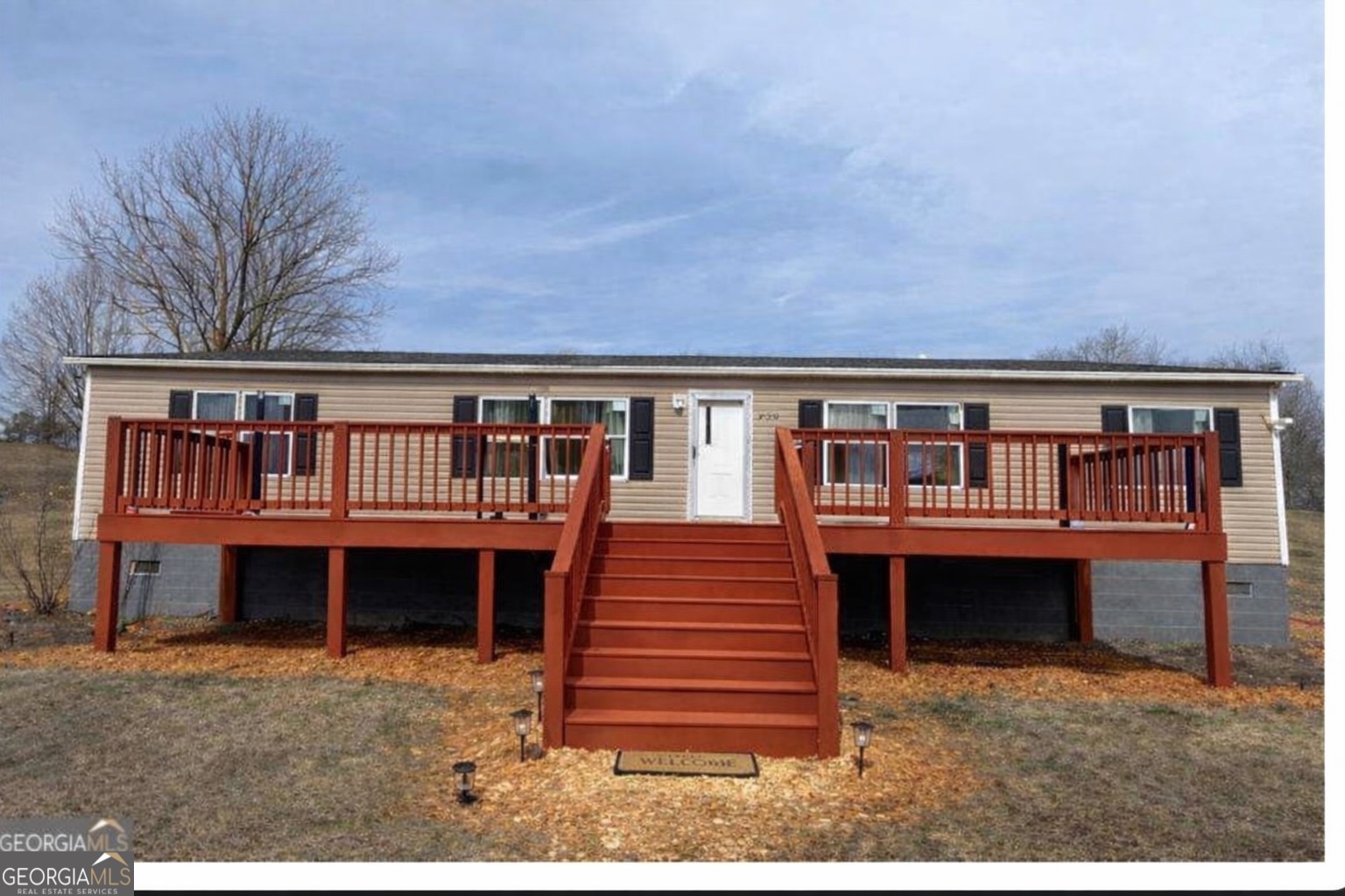 a front view of a house with a yard and balcony