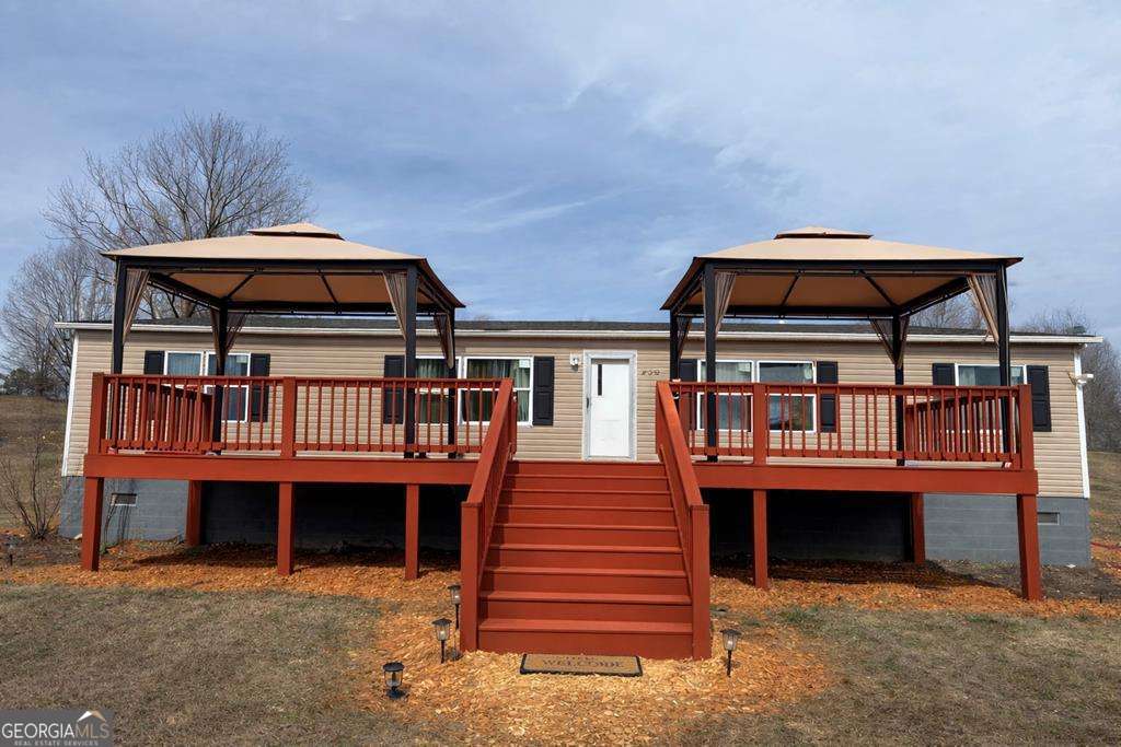 450 Glenloch Road Roopville, GA 30170 - Photo 1 of 60 a front view of a house with a balcony