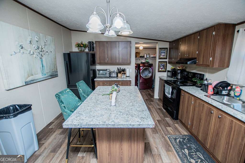 450 Glenloch Road Roopville, GA 30170 - Photo 18 of 60 a kitchen with granite countertop a refrigerator a stove a sink dishwasher and wooden cabinets
