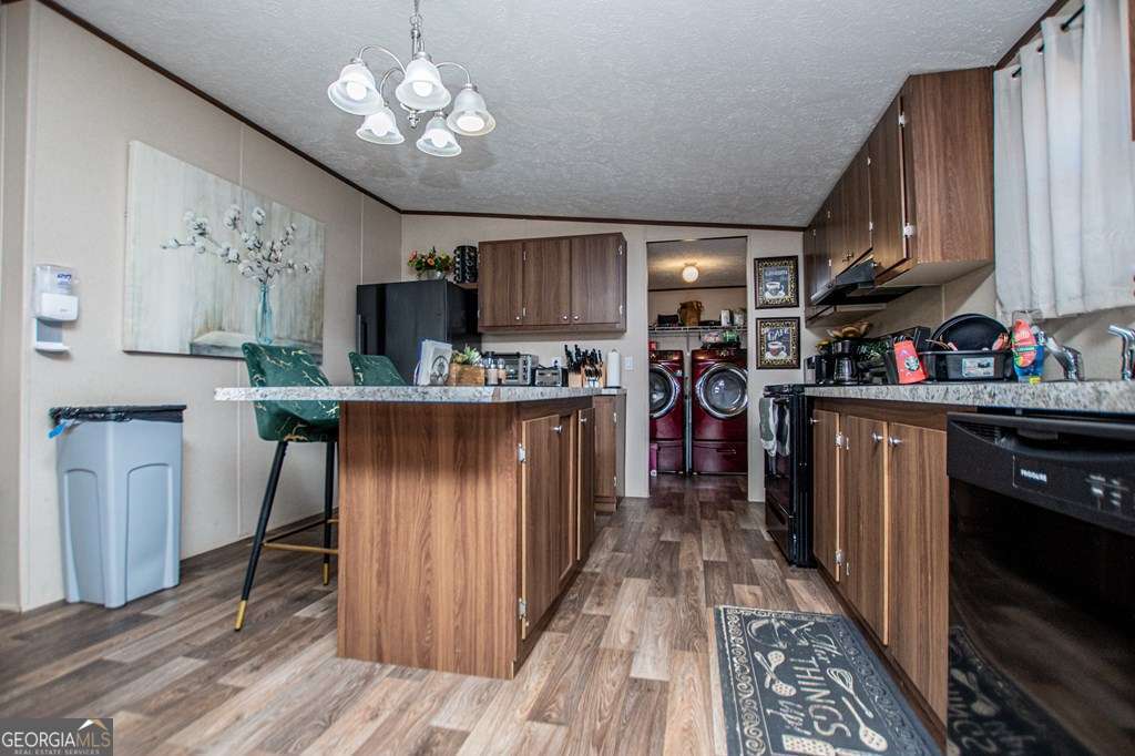 450 Glenloch Road Roopville, GA 30170 - Photo 21 of 60 a kitchen with kitchen island granite countertop a sink stove and cabinets