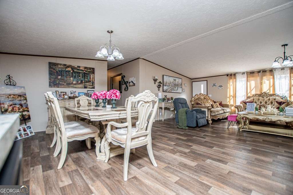 450 Glenloch Road Roopville, GA 30170 - Photo 22 of 60 a view of a dining room with furniture and a chandelier