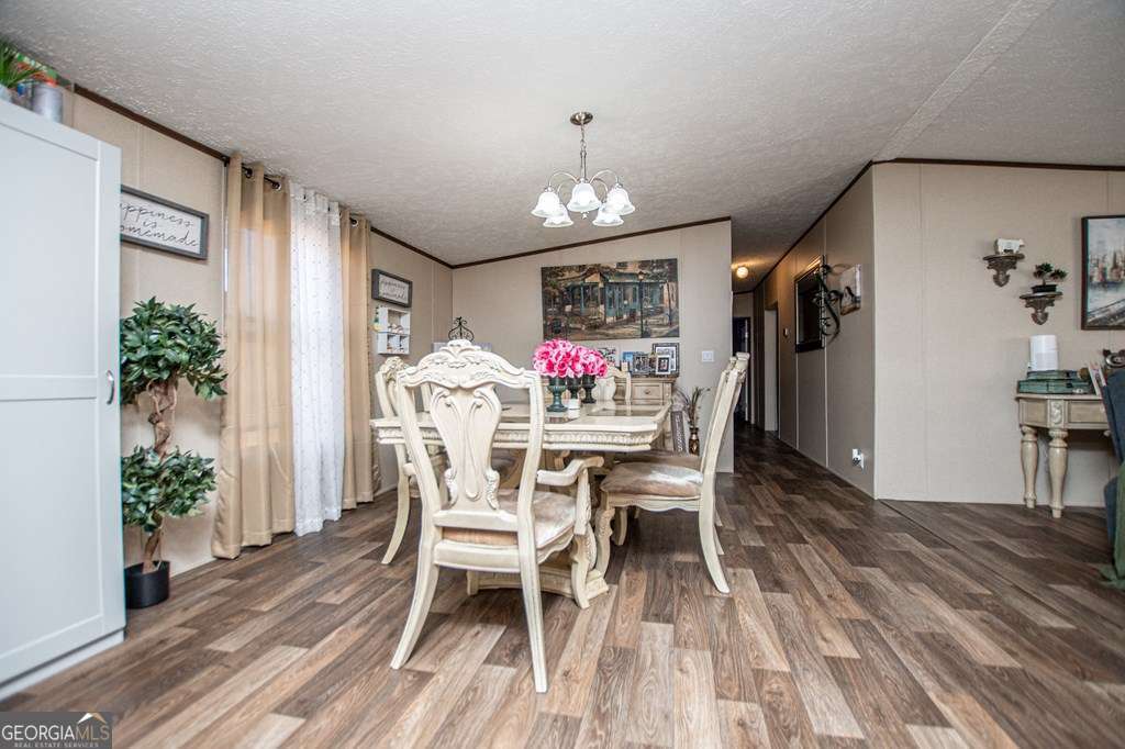 450 Glenloch Road Roopville, GA 30170 - Photo 23 of 60 a view of a dining room with furniture and wooden floor