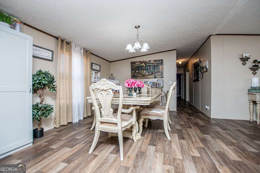 450 Glenloch Road Roopville, GA 30170 - Photo 24 of 60 a view of a dining room with furniture and wooden floor