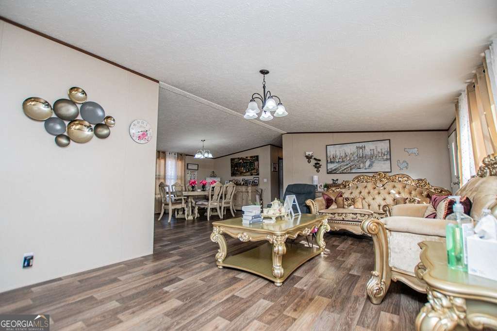 450 Glenloch Road Roopville, GA 30170 - Photo 25 of 60 a living room with furniture and a chandelier