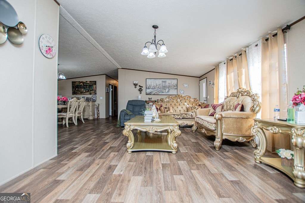 450 Glenloch Road Roopville, GA 30170 - Photo 26 of 60 a living room with furniture and a chandelier