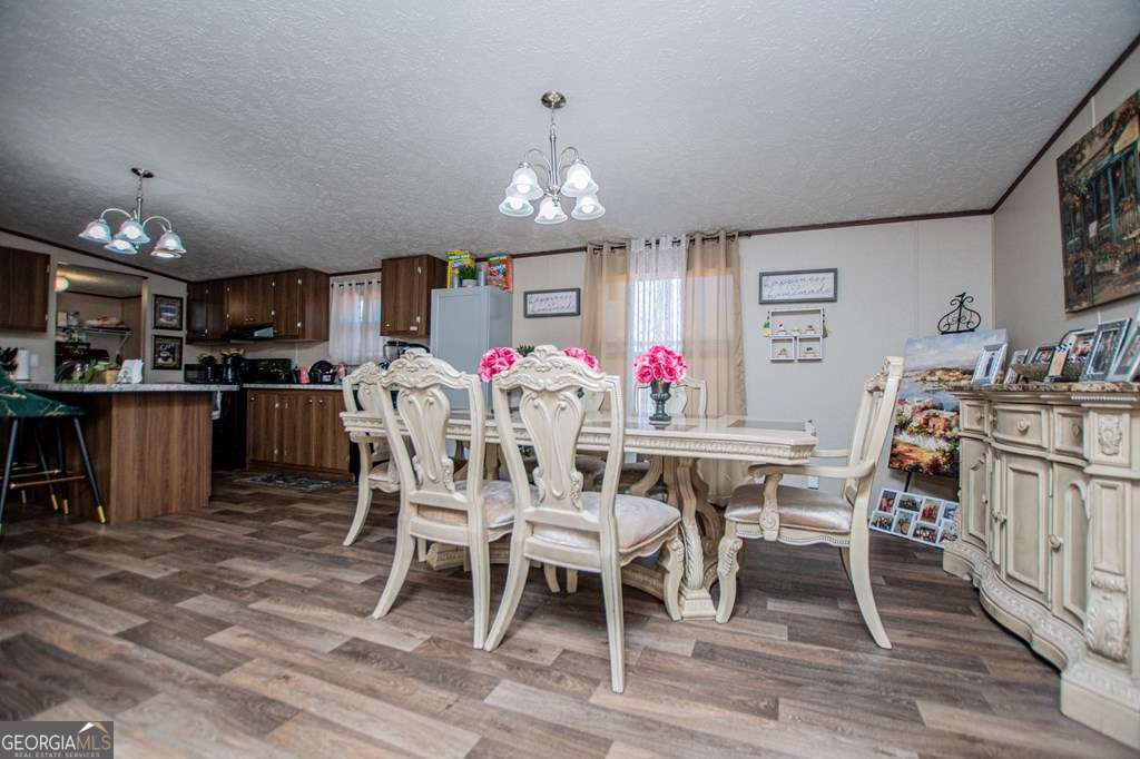 450 Glenloch Road Roopville, GA 30170 - Photo 27 of 60 a view of a dining room with furniture and chandelier