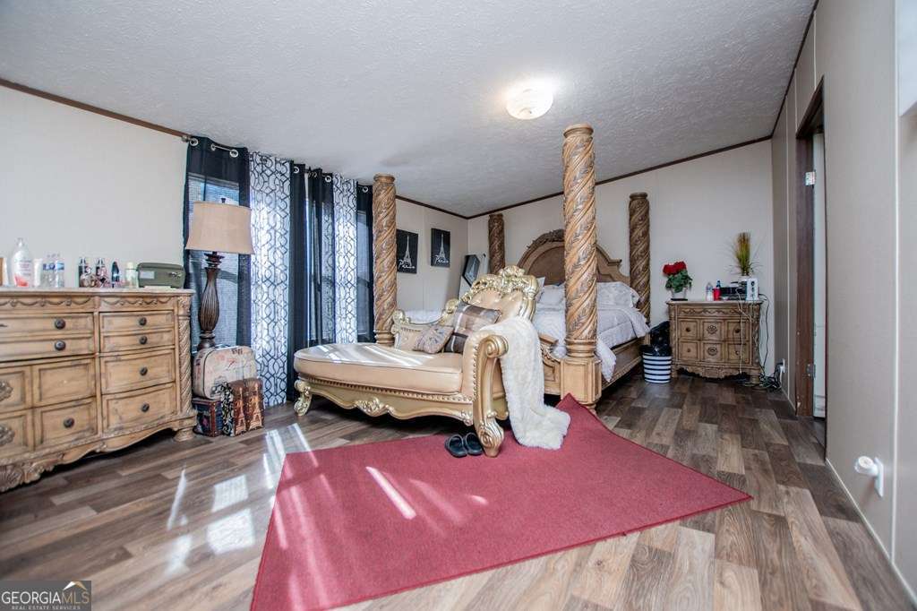 450 Glenloch Road Roopville, GA 30170 - Photo 29 of 60 a bedroom with furniture and a wooden floor