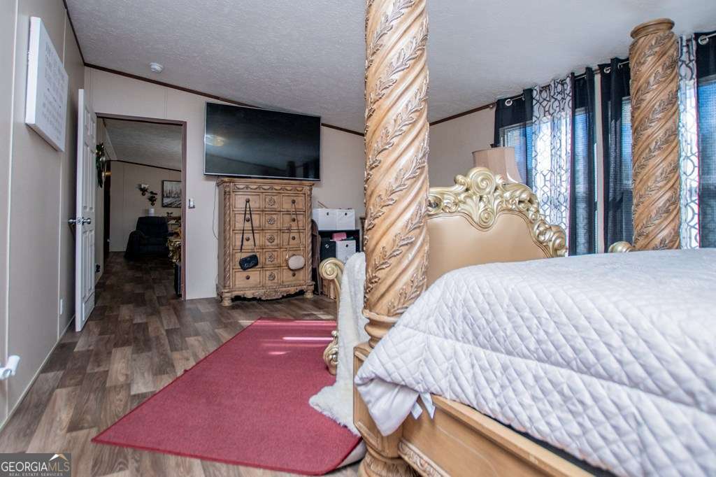 450 Glenloch Road Roopville, GA 30170 - Photo 31 of 60 a bed room with a bed and a television