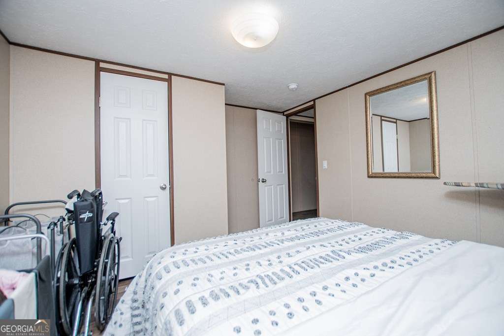 450 Glenloch Road Roopville, GA 30170 - Photo 35 of 60 a bedroom with a bed and a mirror