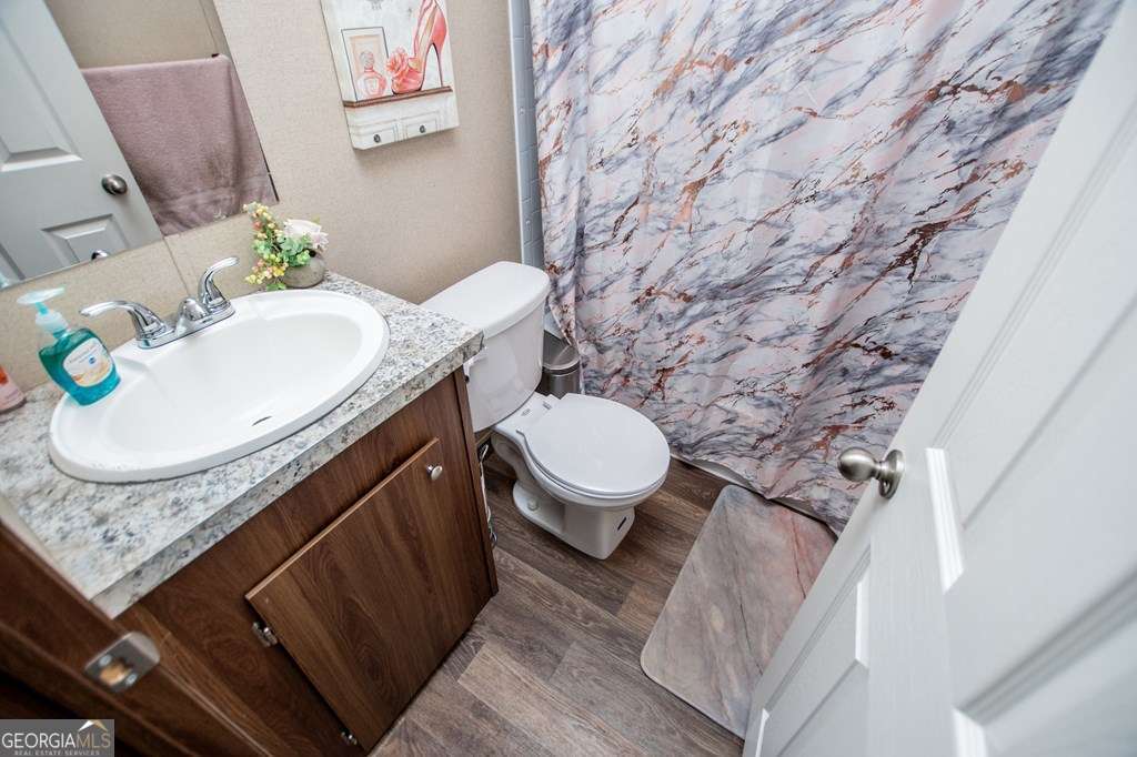 450 Glenloch Road Roopville, GA 30170 - Photo 38 of 60 a bathroom with a granite countertop toilet and a sink