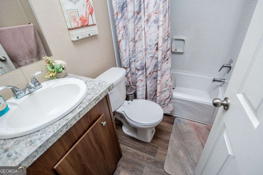 450 Glenloch Road Roopville, GA 30170 - Photo 40 of 60 a bathroom with a granite countertop bathtub sink vanity mirror and toilet
