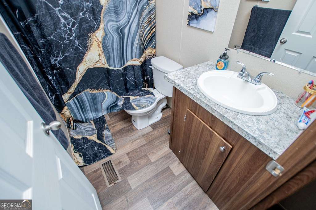 450 Glenloch Road Roopville, GA 30170 - Photo 46 of 60 a bathroom with a granite countertop sink and a mirror