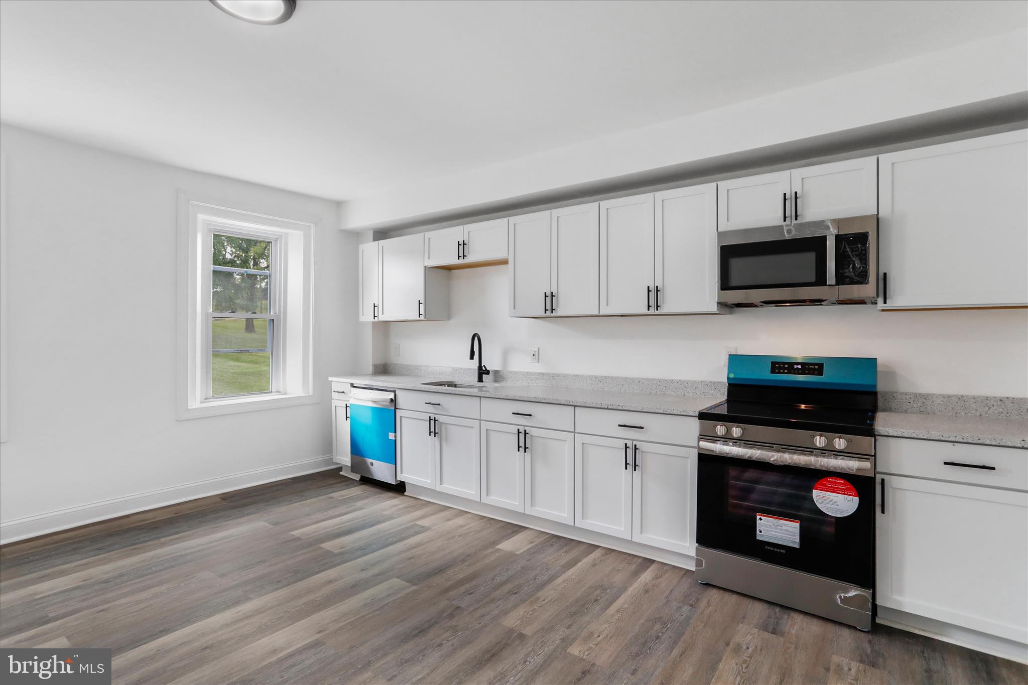 15225 Fairview Road Clear Spring, MD 21722 - Photo 11 of 43 a kitchen with stainless steel appliances granite countertop a stove top oven a sink dishwasher and a microwave oven on the wooden floor