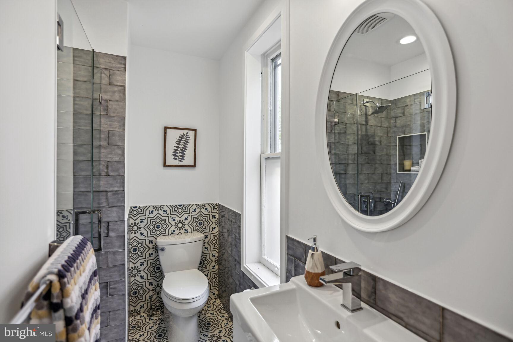 425 5th Street Northeast Washington, DC 20002 - Photo 17 of 25 a bathroom with a toilet a sink and a mirror