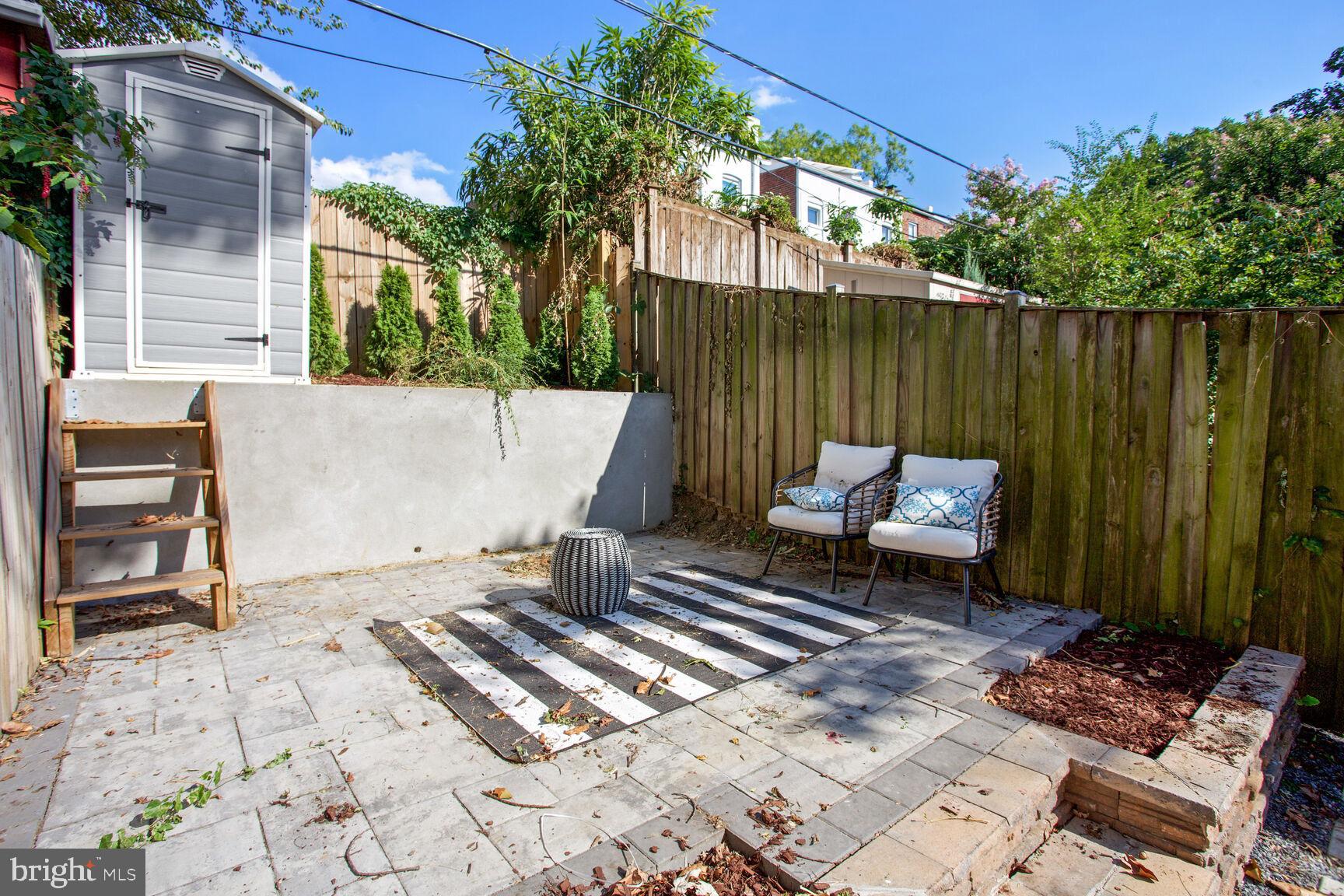 425 5th Street Northeast Washington, DC 20002 - Photo 21 of 25 a backyard of a house with chairs and a fire pit