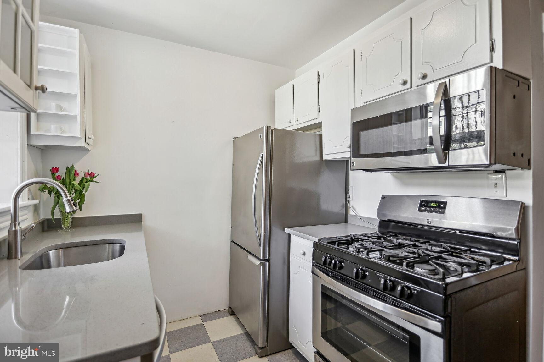 425 5th Street Northeast Washington, DC 20002 - Photo 10 of 25 a kitchen with stainless steel appliances granite countertop a sink stove and refrigerator
