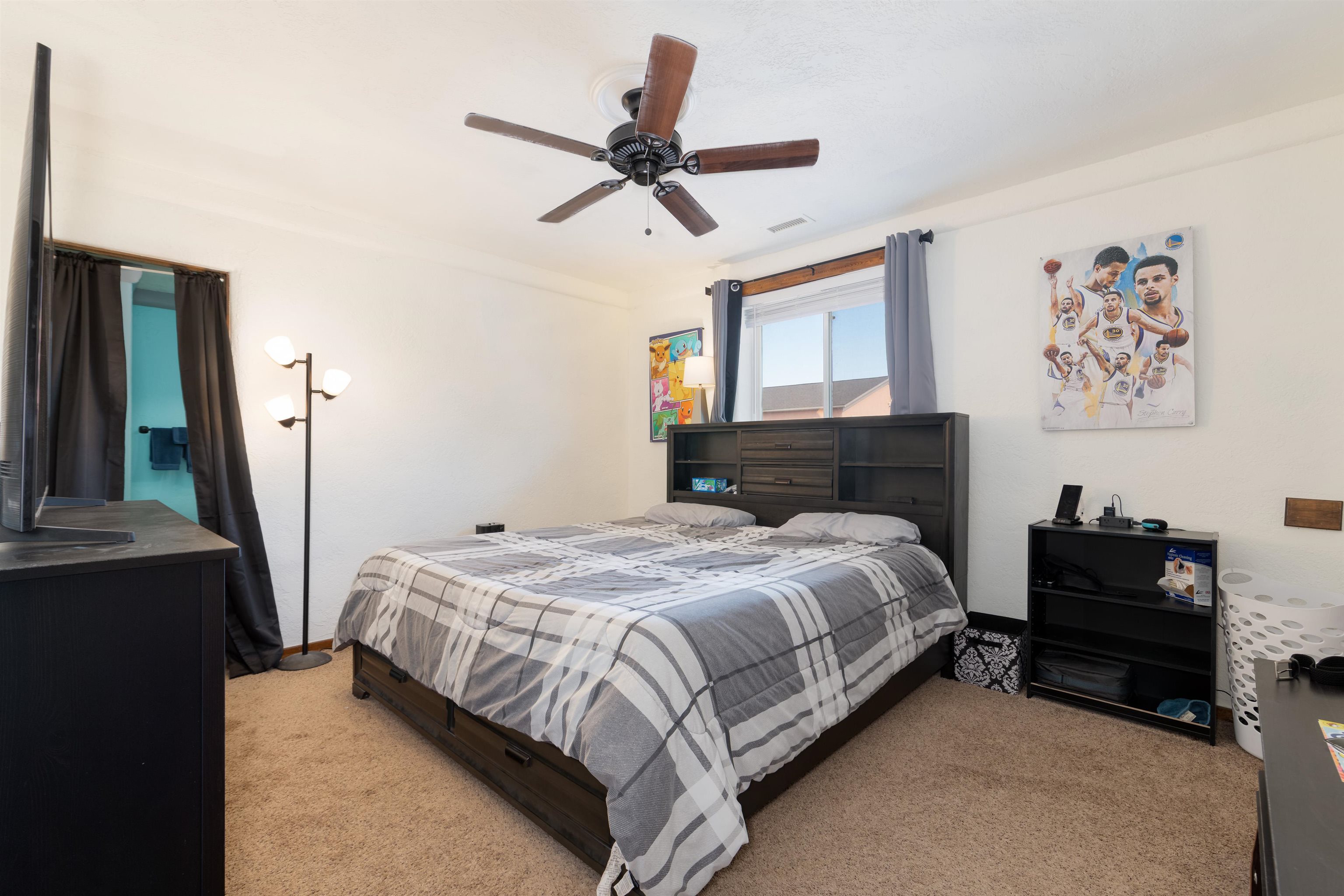 33376 Mill Tailing Road Whitewater, CO 81527 - Photo 20 of 42 a bedroom with a bed and a chandelier