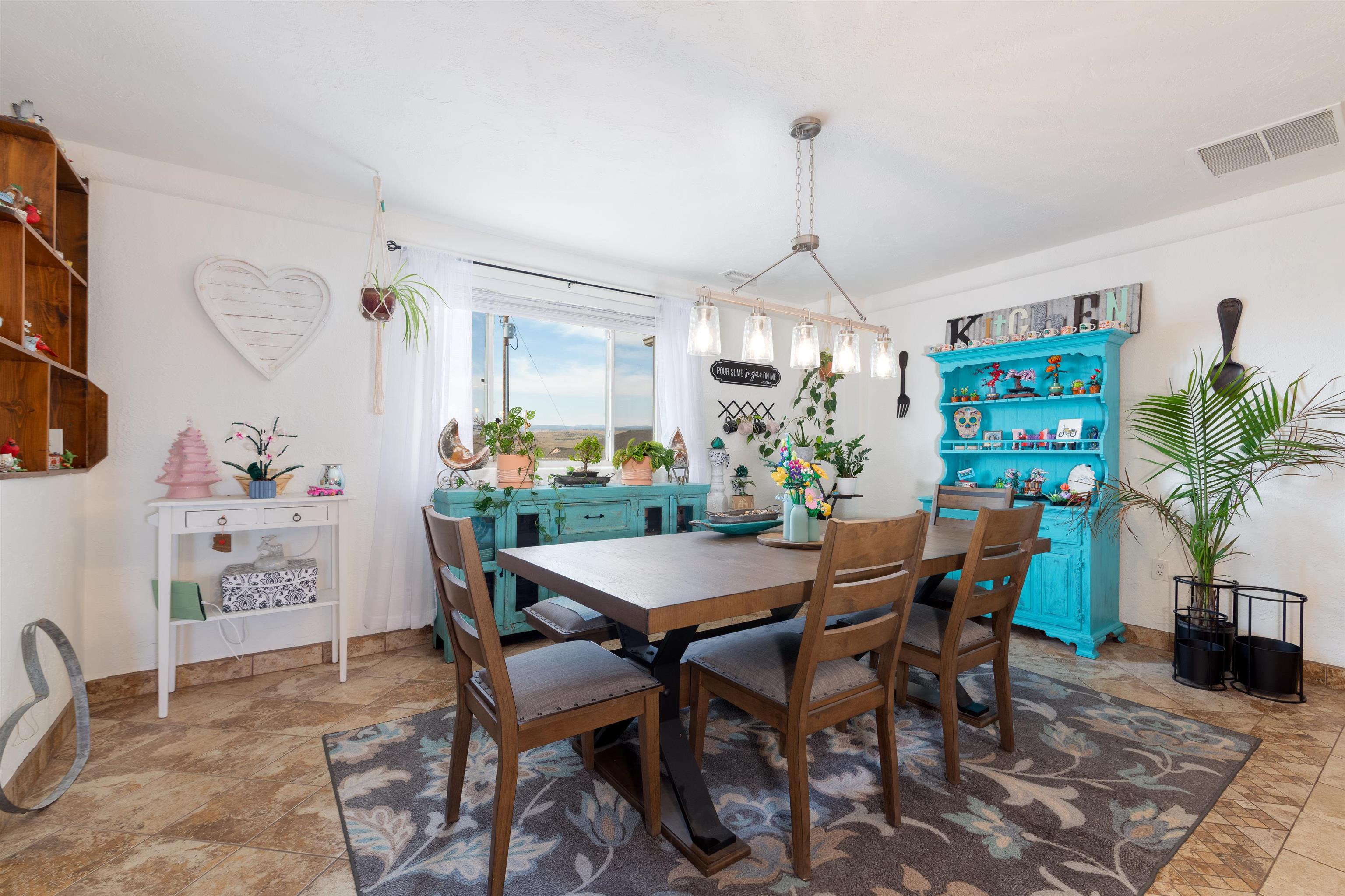33376 Mill Tailing Road Whitewater, CO 81527 - Photo 6 of 42 a view of a dining room with furniture and chandelier