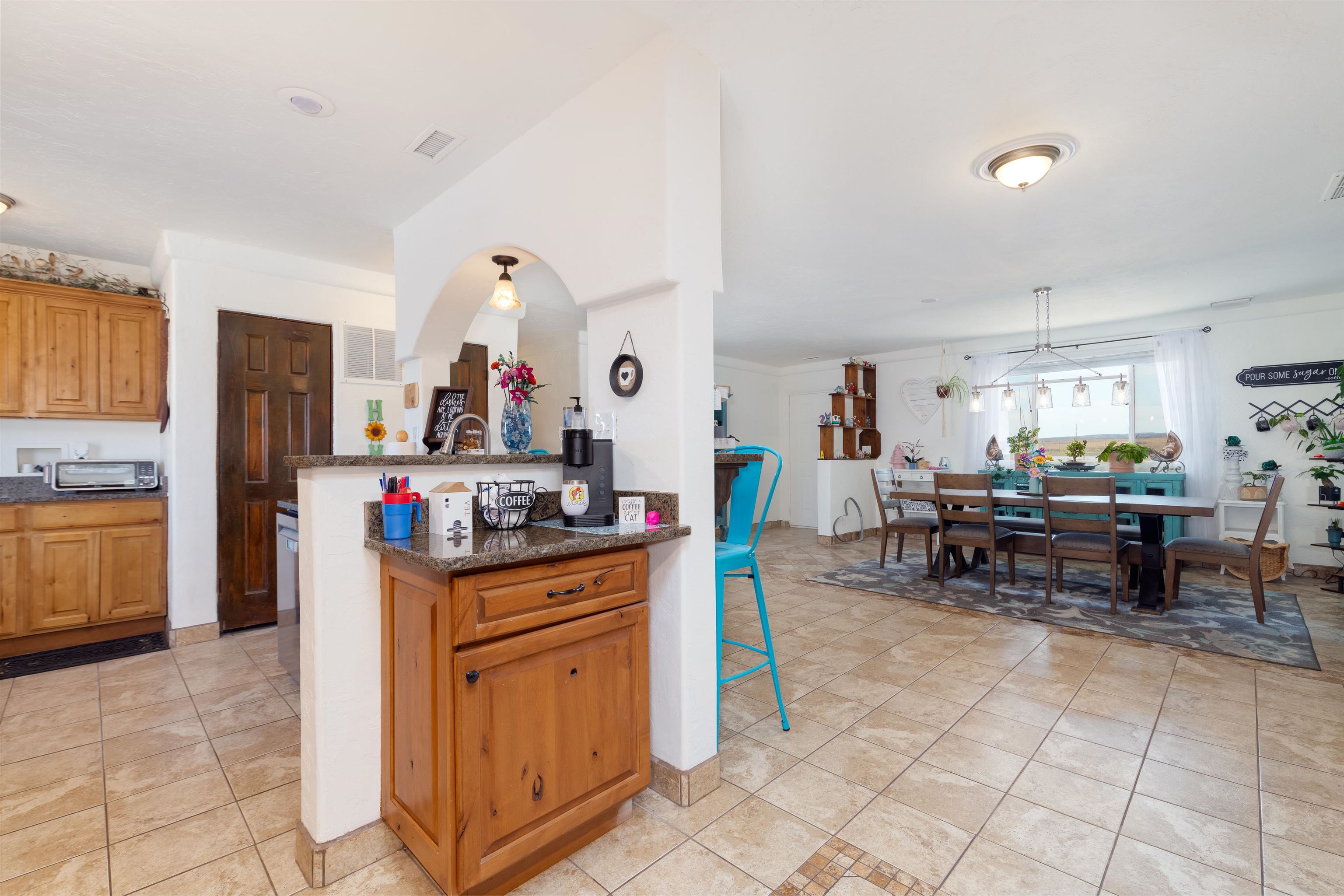 33376 Mill Tailing Road Whitewater, CO 81527 - Photo 10 of 42 a kitchen with granite countertop a table and chairs in it