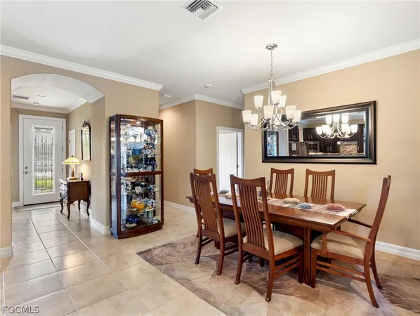 a view of a dining room with furniture and chandelier