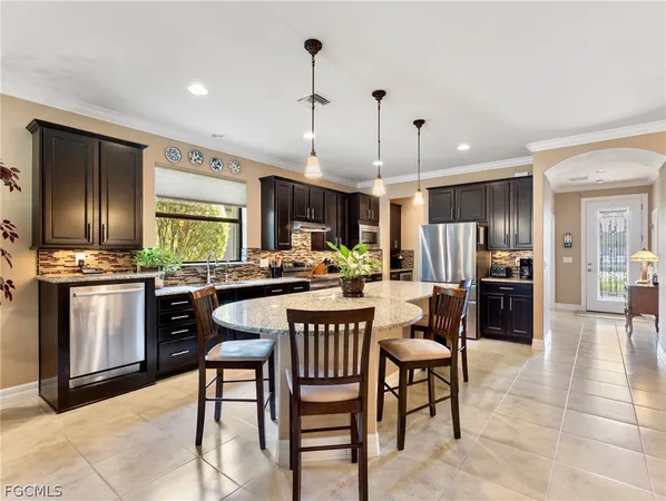 a kitchen with a table chairs refrigerator and chairs